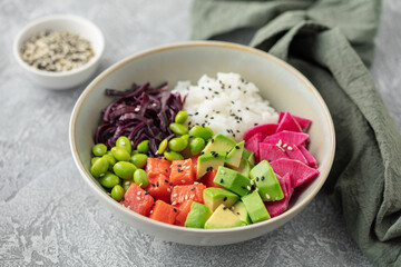 Poke bowl with salmon, avocado, radish, red cabbage, edamame beans and rice. Hawaiian cuisine
