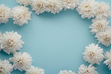 Obraz premium Sophisticated Mother's Day scene from top view, displaying fresh blooming chrysanthemums within a heart-shaped frame on a soft blue background, space for custom messages 