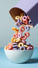 Bowl of colorful cereal is poured out of a box