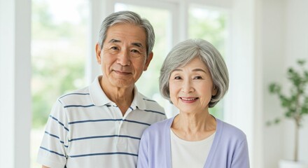 Obraz premium Happy Elderly Japanese Couple Smiling in a Bright and Peaceful Home Setting