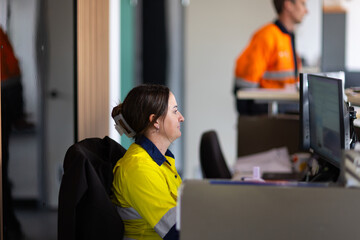 Young adult woman working in front of the computer in the office.