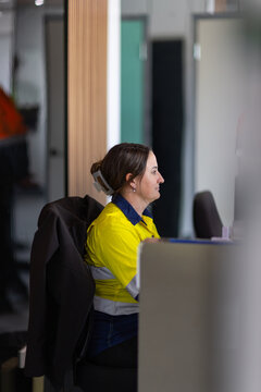 Young adult woman working in front of the computer in the office.