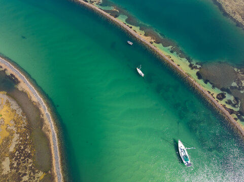 Aerial view of yachts anchored in a calm torquoise coastal river