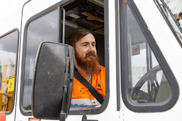 adult worker on the trucks driver seat of crane