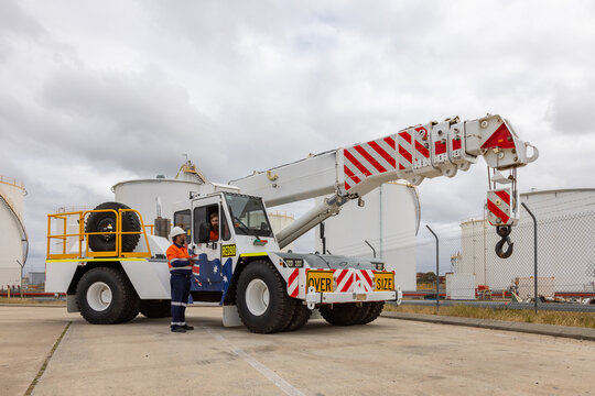 worker man standing beside the pick and carry crane