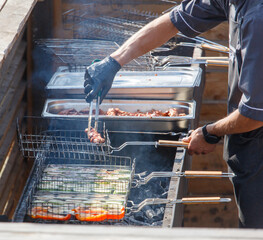 A man is cooking food on a grill
