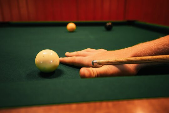 Close up of hands taking shot in pool game