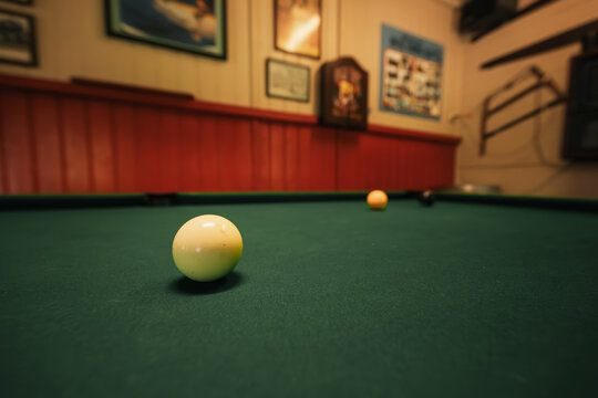 Billiard balls scattered on pool table mid-game in Aussie pub