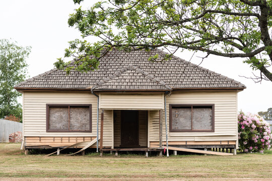 street view of regional suburban 60's style house in need of repair