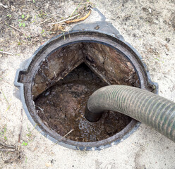 A dirty pipe is being cleaned out by a plumber