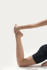 Young woman practicing stretching yoga positions, wellbeing and self care concept	