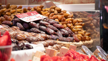 fresh fruits displayed on public market shelf with fresh dehydrated dates with strawberry
