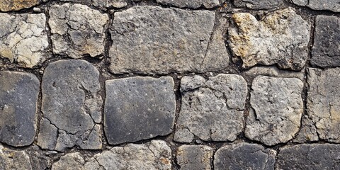 Obraz premium Fragment of an aged stone sidewalk provides a textured background, showcasing the unique characteristics of an old stone sidewalk that enhances various creative projects.