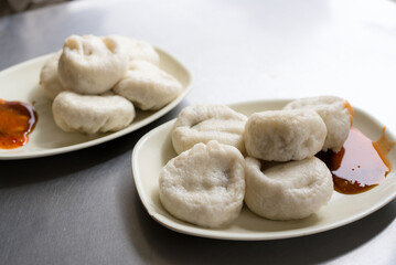 Steamed dumplings with sauce on plate