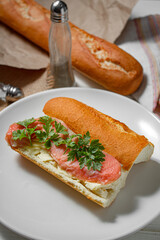 Sandwich with smoked red fish on a light table