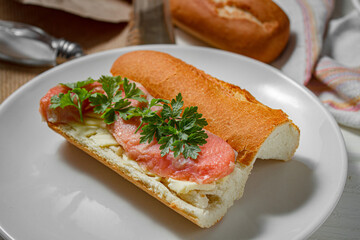 Sandwich with smoked red fish on a light table