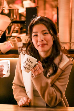 Woman enjoying coffee in Melbourne laneway with'Mrs Always Right' mug