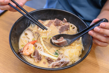 Authentic Korean Malatang Hotpot with Fresh Ingredients and Noodles in a Casual Restaurant Setting