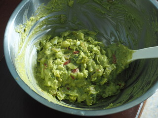mixing guacamole in bowl