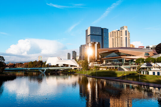 Fototapeta View of Adelaide city across the Torrens River with bright afternoon sunlight reflecting