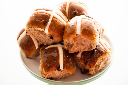hot cross buns in a pile on a white background