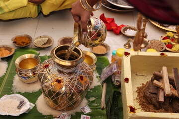 kumbum a decorative pot kept in hindu pooja as a sacred item, pouring holy water into the kumbham