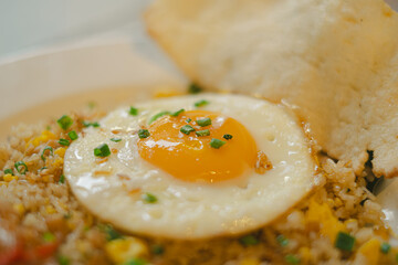 Indonesian Fried Rice with sunny side egg with bokeh background