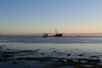 A ship stranded near a seawall on the coast of Chile
