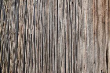 The abstract background of the old wooden surface is wet after rain. Closeup topview for artworks.Old wooden texture and background. Brown old oak wood table surface with knots and scratches.Dark wood