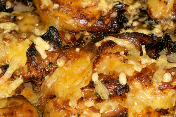 Close Up Of Golden Roasted Smashed or Crushed Potatoes on a Baking Tray
