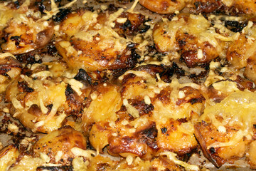 Close Up Of Golden Roasted Smashed or Crushed Potatoes on a Baking Tray