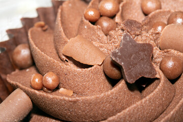 Close Up of Cupcake Cake Icing and Frosting in Chocolate with ball Decoration