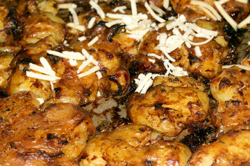 Close Up Of Golden Roasted Smashed or Crushed Potatoes on a Baking Tray