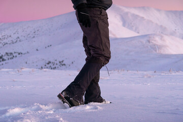 Man's legs close-up. Boot And Gaiters Of Mountaineer On The Snowy Path.