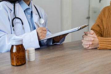 Female Doctor Providing Health Advice and Medicine Guidance in a Professional Medical Setting