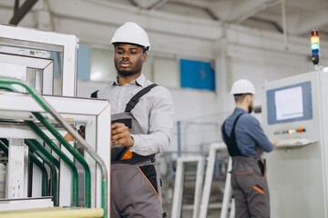 Factory workers producing aluminum and pvc windows and doors