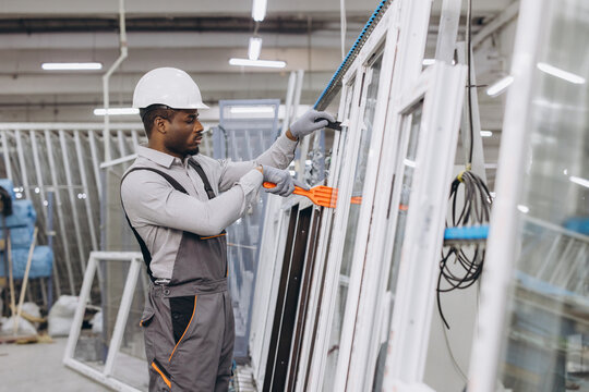 Factory worker assembling aluminum and pvc windows and doors - Powered by Adobe