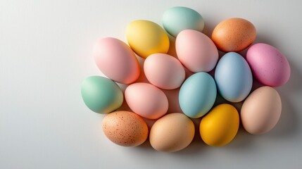 A vibrant assortment of Easter eggs in various colors, such as pink, blue, yellow, and green, are arranged in a circular pattern on a clean white background, creating a festive and cheerful display.
