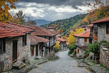 Fototapeta premium Charming stone village street, autumn foliage, mountains.