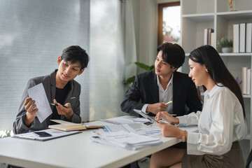 Asian Business Team Meeting for Idea Exchange and Discussion in Modern Office Setting