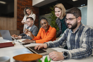 Group of People Working on Laptops at Table