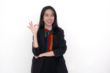 Young female manager standing in her black blazer, gesturing an agreement with her right hand