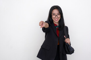 Asian businesswoman standing and pointing her fore finger towards someone