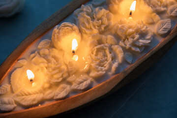 Beautiful candle with flowers in a wooden candlestick