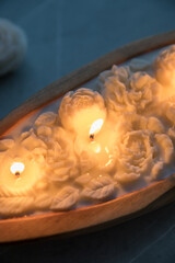 Beautiful candle with flowers in a wooden candlestick