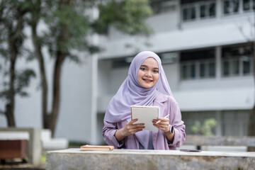 Smiling Muslim Girl Student in Hijab Holding Notebook Outdoors at University Campus, Education and...