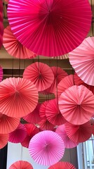 Obraz premium A room with pink paper lanterns hanging from the ceiling. The room has a pink and white color scheme