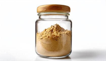 A glass jar filled with ground ginger is presented against a white background