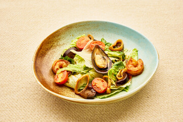 A plate of food with a variety of ingredients including tomatoes, mushrooms