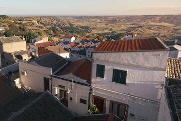 Ancient town hill side with levels of whitewashed houses and tiled roofs, Pisticci, Basilicata, Italy